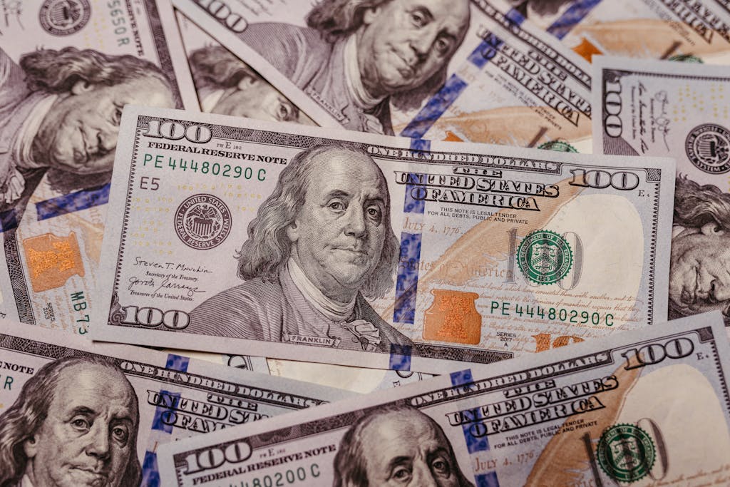 Stack of 100 dollar US banknotes with Benjamin Franklin portrait.